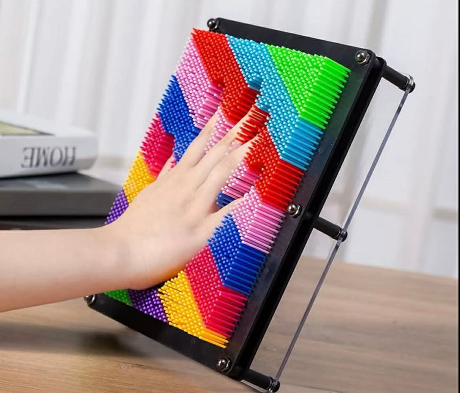 Hand pressing into Neuro Touch 3D Rainbow Pin Art – tactile sensory tool for focus and calm by The Divergent Den
