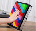 Hand pressing into Neuro Touch 3D Rainbow Pin Art – tactile sensory tool for focus and calm by The Divergent Den
