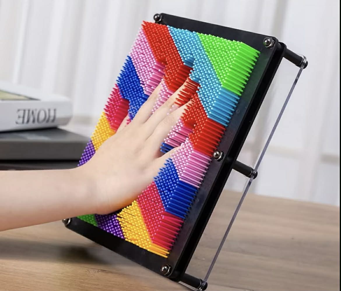 Hand pressing into Neuro Touch 3D Rainbow Pin Art – tactile sensory tool for focus and calm by The Divergent Den