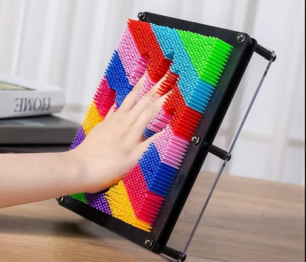 Hand pressing into Neuro Touch 3D Rainbow Pin Art – tactile sensory tool for focus and calm by The Divergent Den