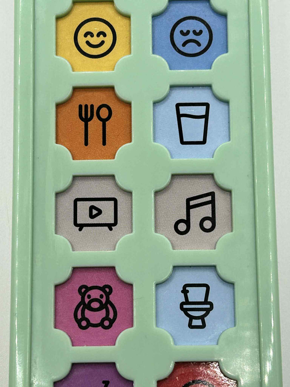Close-up of ASD Communication Device showing colourful communication buttons and icons for visual learning