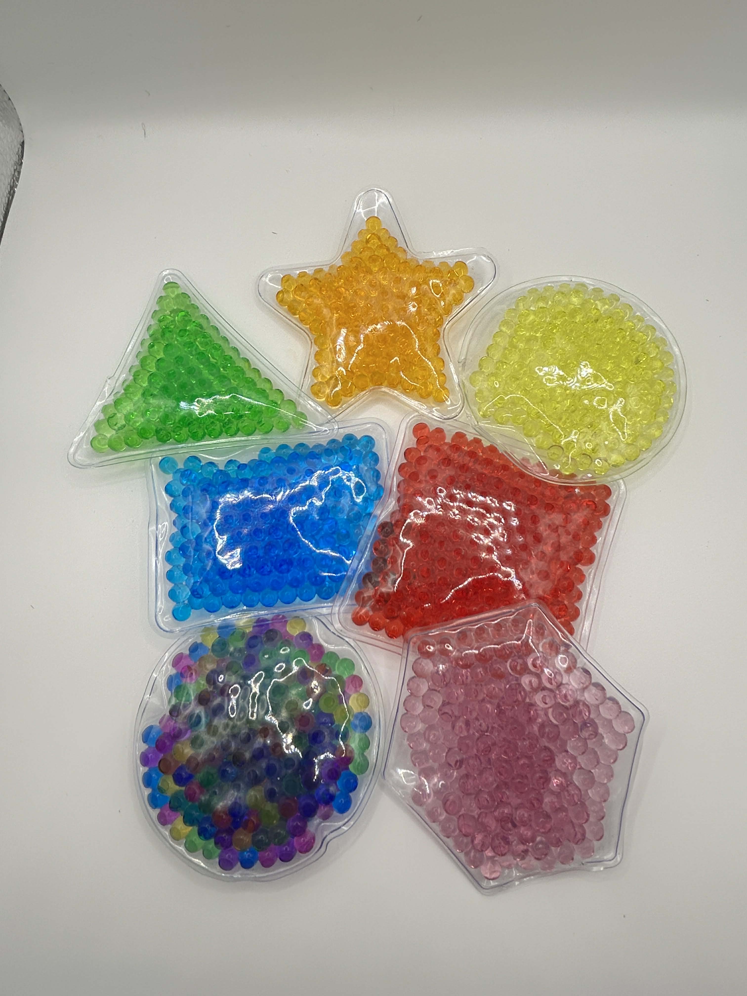 Colorful star-shaped gel beads in clear containers on a white background