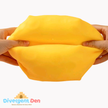 Yellow putty being stretched between two hands with Divergent Den logo in the corner.