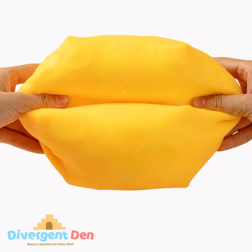 Yellow putty being stretched between two hands with Divergent Den logo in the corner.
