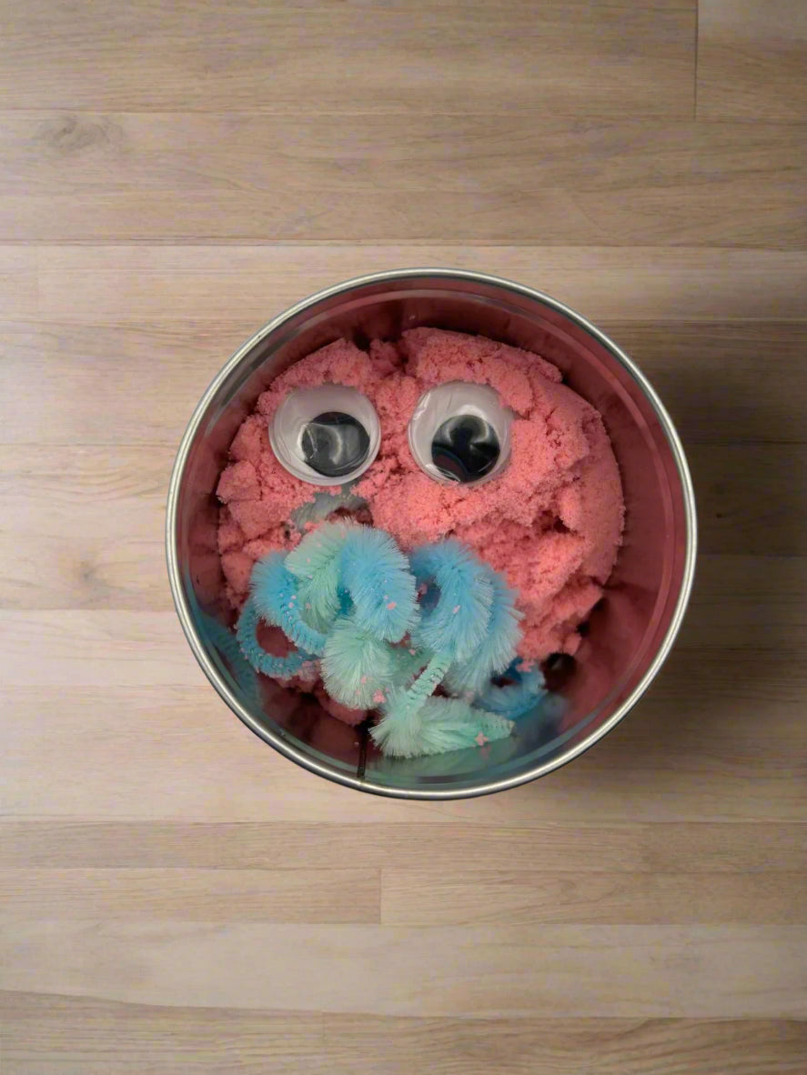 Close-up of the pink option for the colourful modelling sand from Create Your Own Monster Sensory Set for tactile sensory play