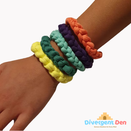 Person wearing fabric t-shirt oral sensory bracelet on wrist, showing discreet chewable design
