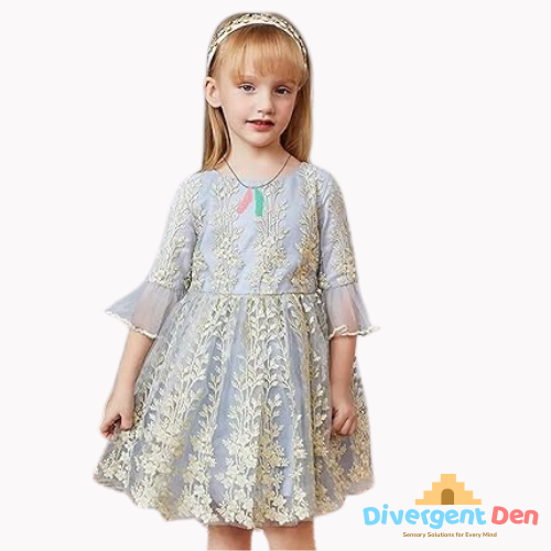 Young girl wearing a light blue dress with floral patterns on a white background, featuring the Divergent Den logo. Child wearing Feather Chewable Necklace for oral sensory input at school