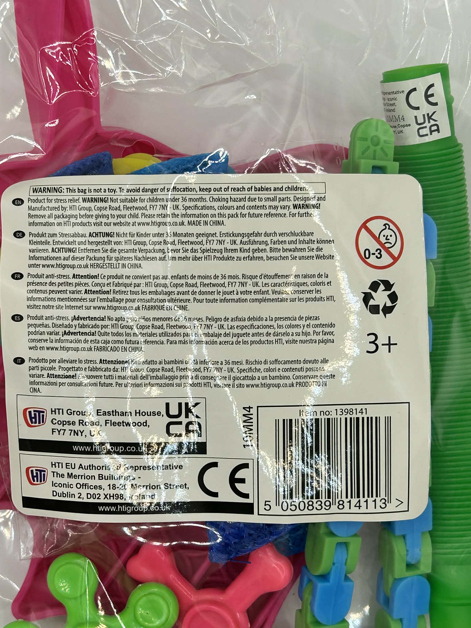 Back of a package with colorful fidget spinners and safety warning labels.