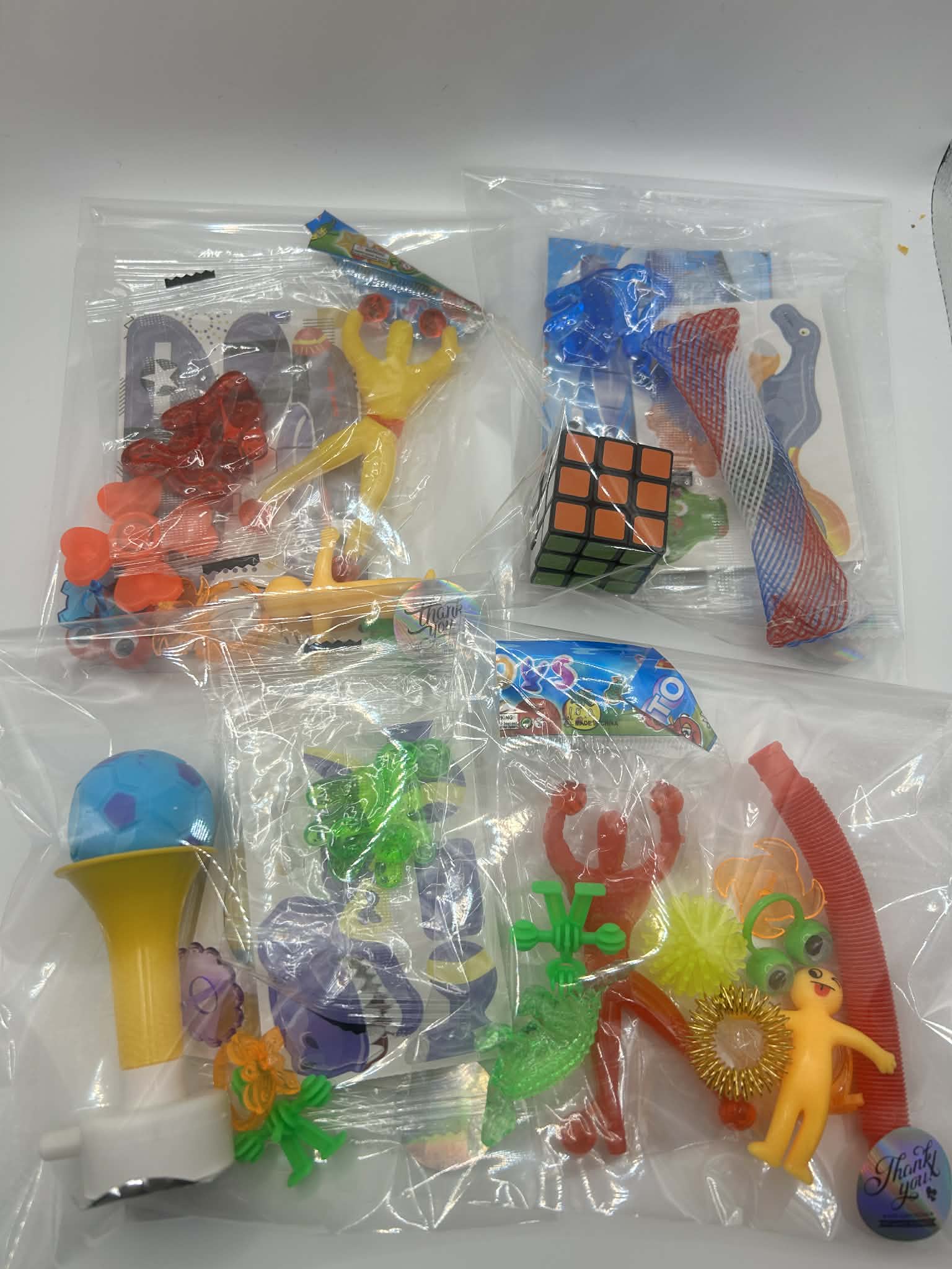 Assorted sensory fidget toys toys in clear plastic bags on a white background for neurodivergent people