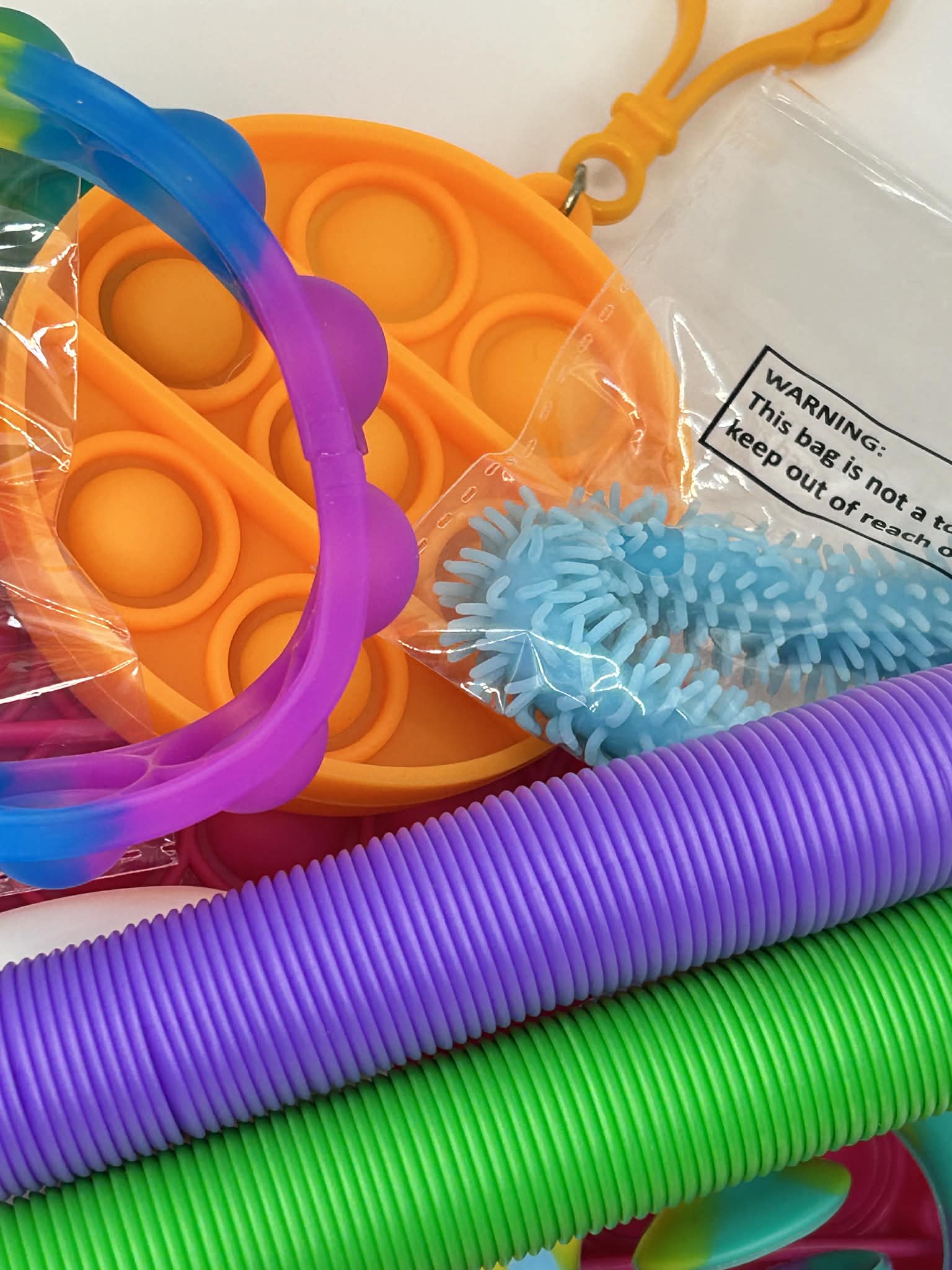 Curated fidget bundle with 9, 12 and 20 piece premium sensory tools including stress balls, fidget spinners, and tactile manipulatives for focus and calm