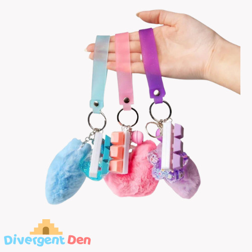 Fluffy Fidget Keychain showing the three colours available, pink blue and purple. 