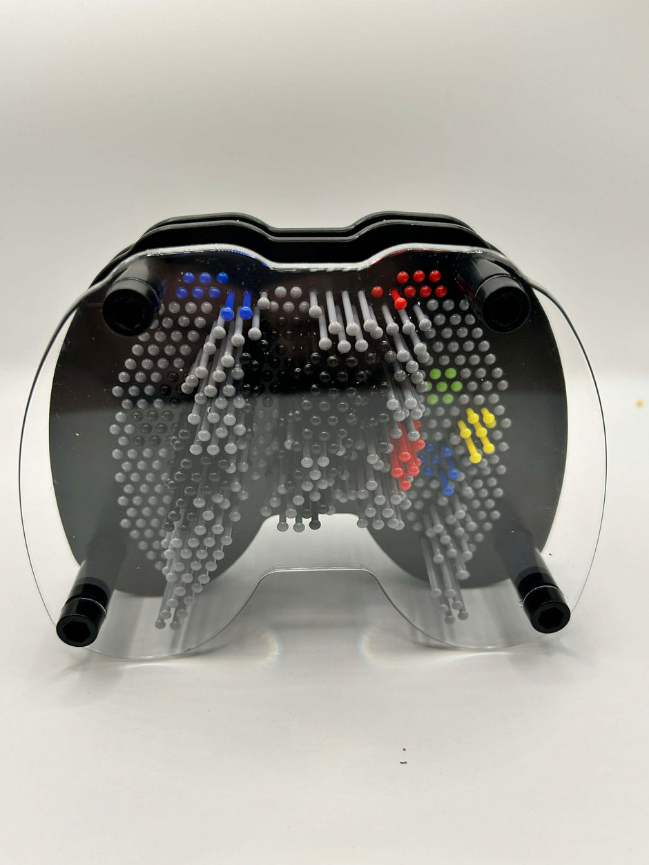 lose up of plastic pins on games controller pin art showing tactile sensory feedback