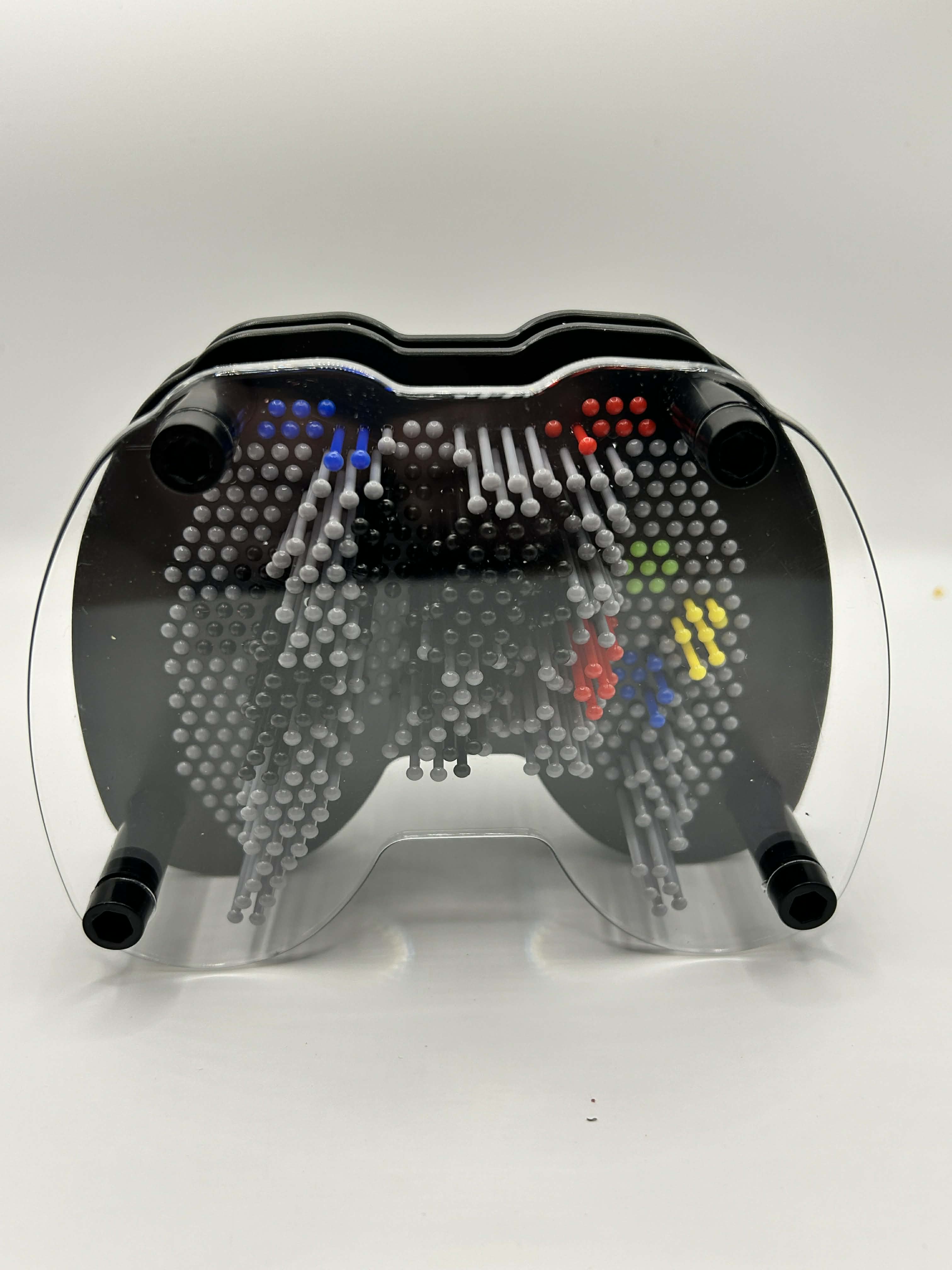 lose up of plastic pins on games controller pin art showing tactile sensory feedback