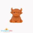 Squeeze toy Highland cow with packaging on a white background