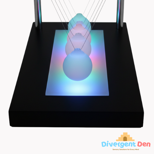 Close up of the illuminated newtons cradle  showing the balls lit up | The Divergent Den