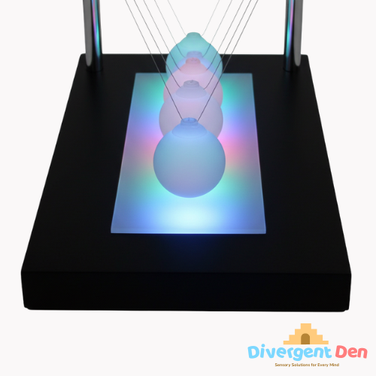 Close up of the illuminated newtons cradle  showing the balls lit up | The Divergent Den