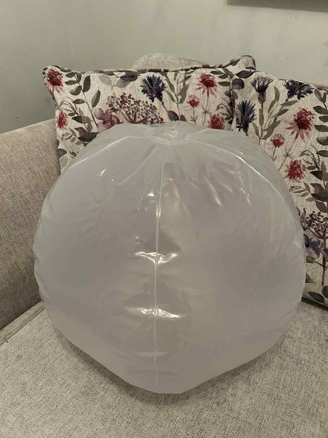 Inflatable 45cm Glow Ball touch activated, this shows the size of the ball sat on a sofa – sensory light toy for kids by The Divergent Den
