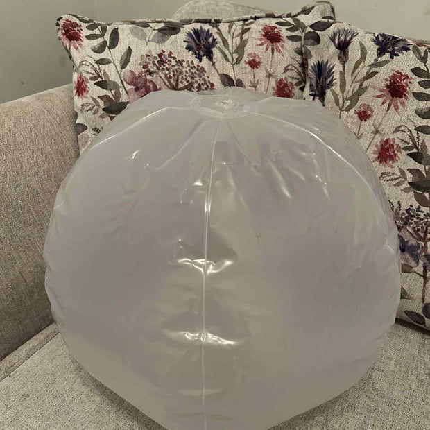 Inflatable 45cm Glow Ball touch activated, this shows the size of the ball sat on a sofa – sensory light toy for kids by The Divergent Den