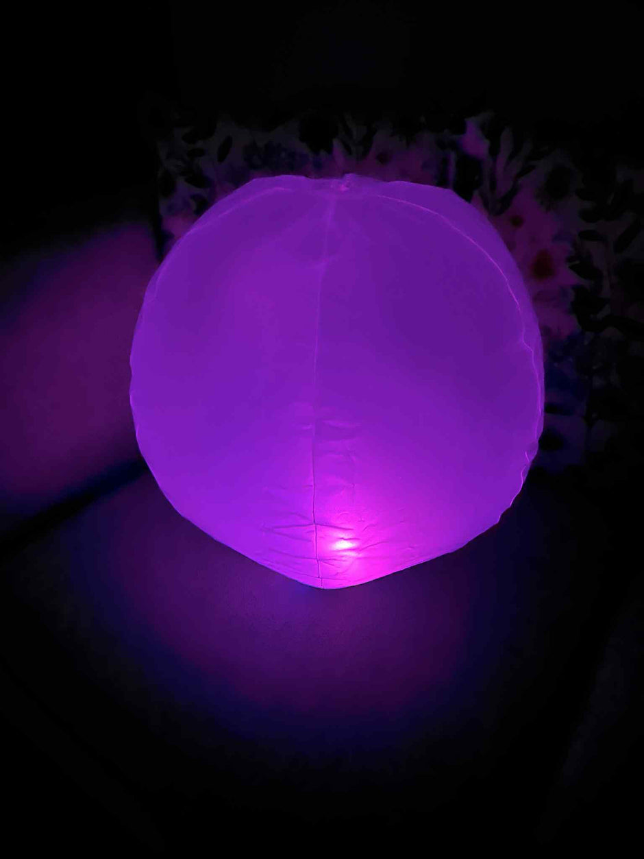 Inflatable 45cm Glow Ball glowing bright purple – sensory light toy for kids by The Divergent Den