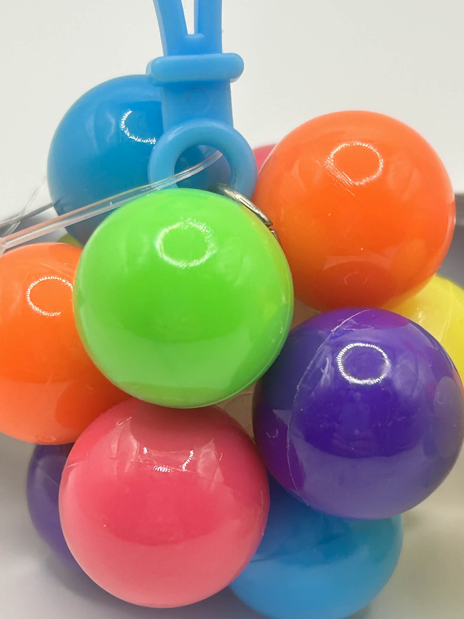 Fidget Atom close-up of label showing UCKA Number showing multi-coloured tactile buttons for stress relief and focus