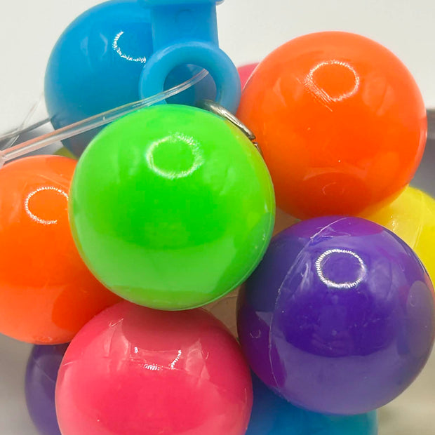 Fidget Atom close-up of label showing UCKA Number showing multi-coloured tactile buttons for stress relief and focus