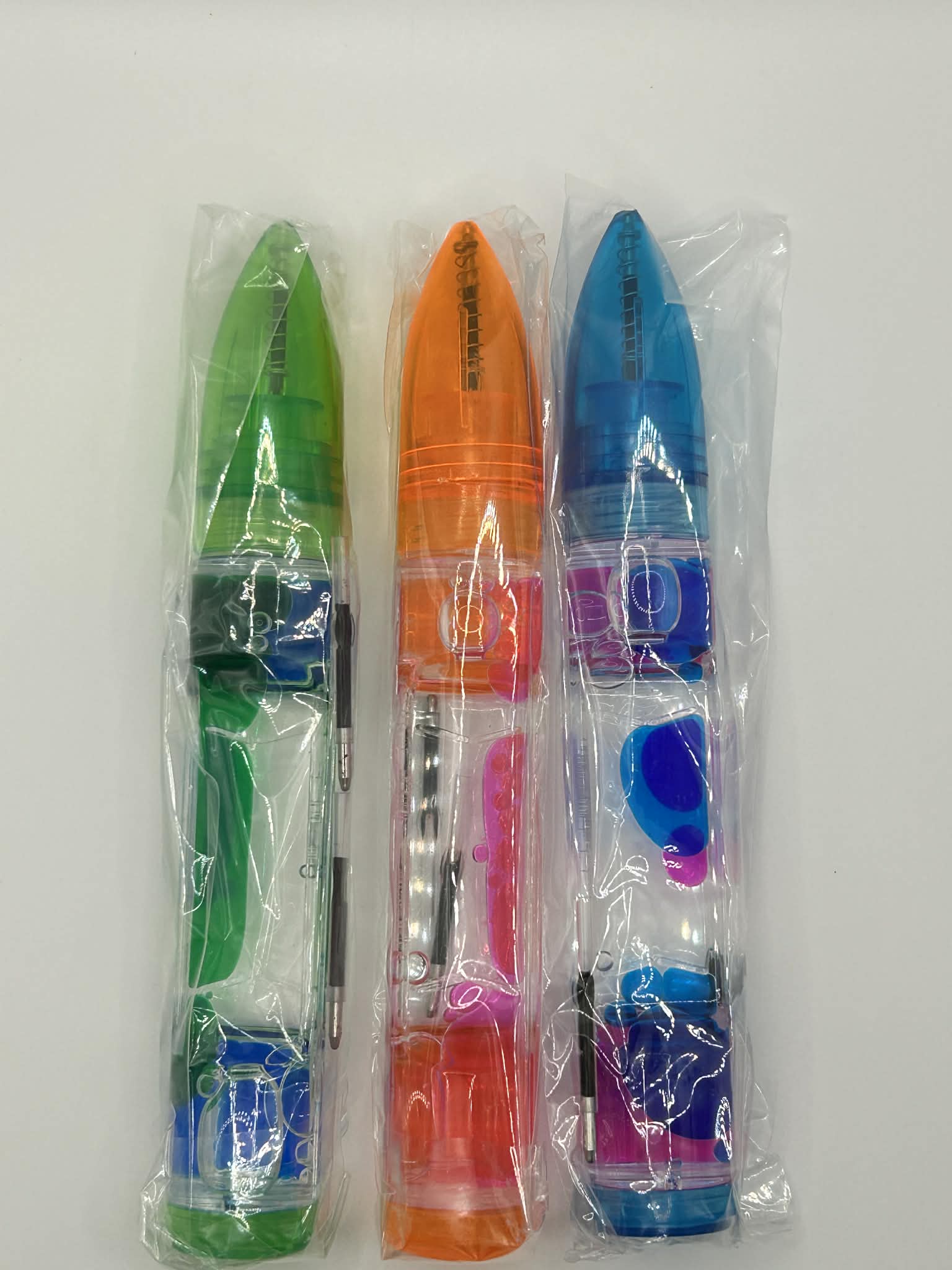 3 pens shown in orange, green and blue. Liquid motion pen perfect for those with neurodivergence looking for calm and focus 