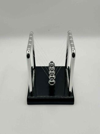Metal Newton’s Cradle on black base – desktop fidget and stress-relief toy for neurodivergent children | The Divergent Den