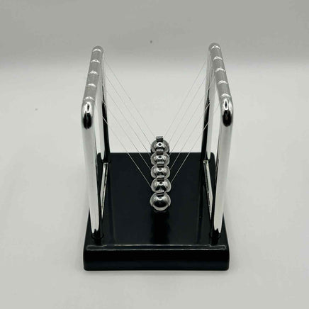 Metal Newton’s Cradle on black base – desktop fidget and stress-relief toy for neurodivergent children | The Divergent Den