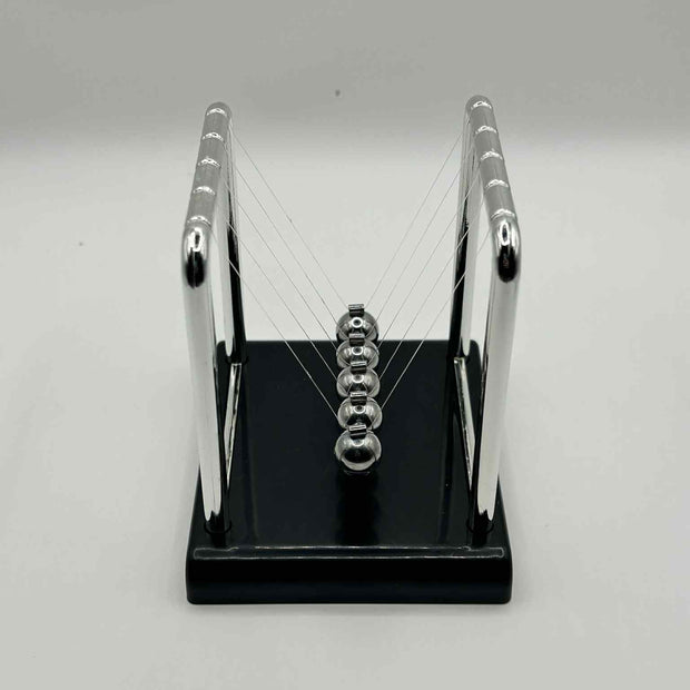 Metal Newton’s Cradle on black base – desktop fidget and stress-relief toy for neurodivergent children | The Divergent Den