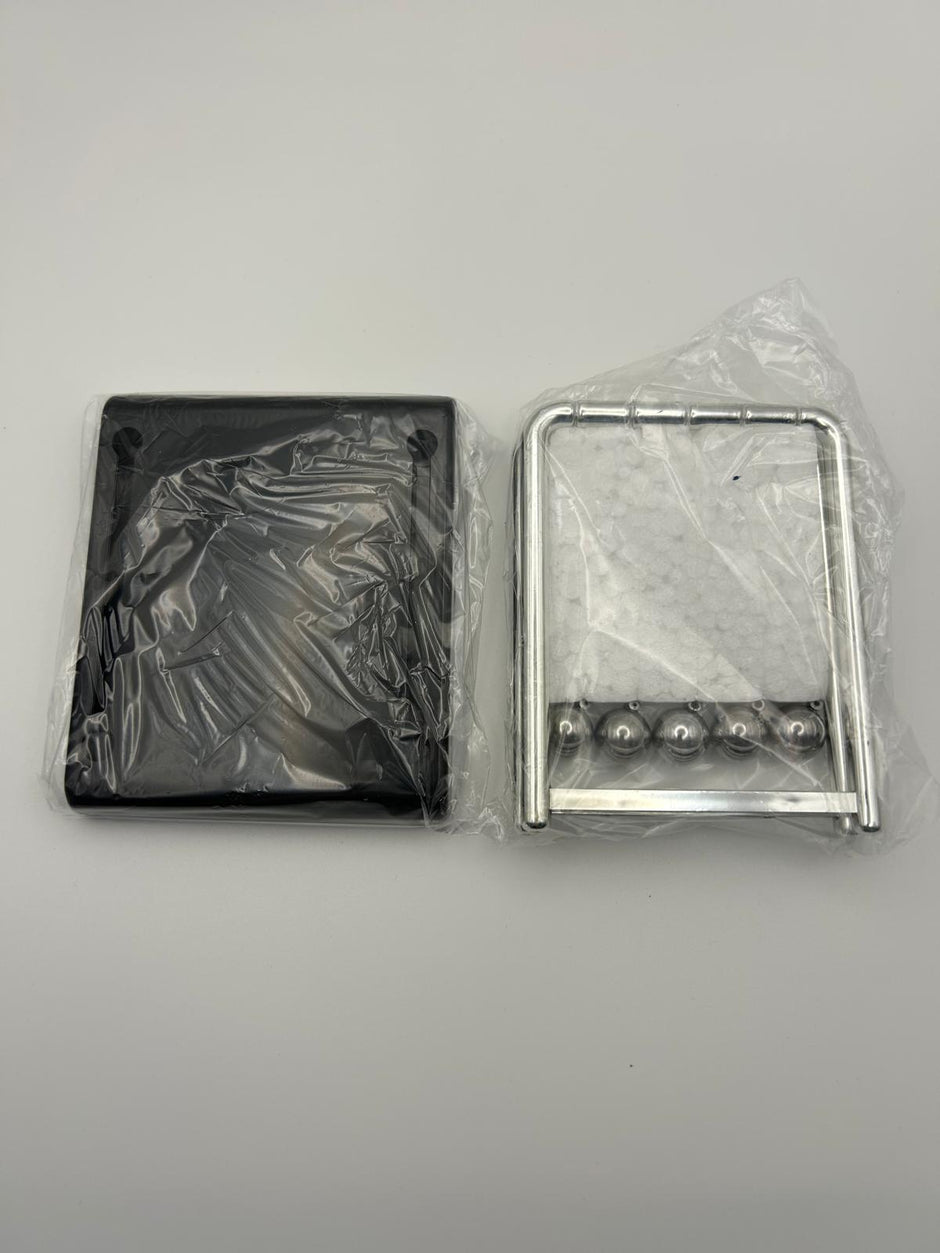 Newton’s Cradle packaging in its film to show what it looks like  – desktop fidget and sensory stress relief toy | The Divergent Den