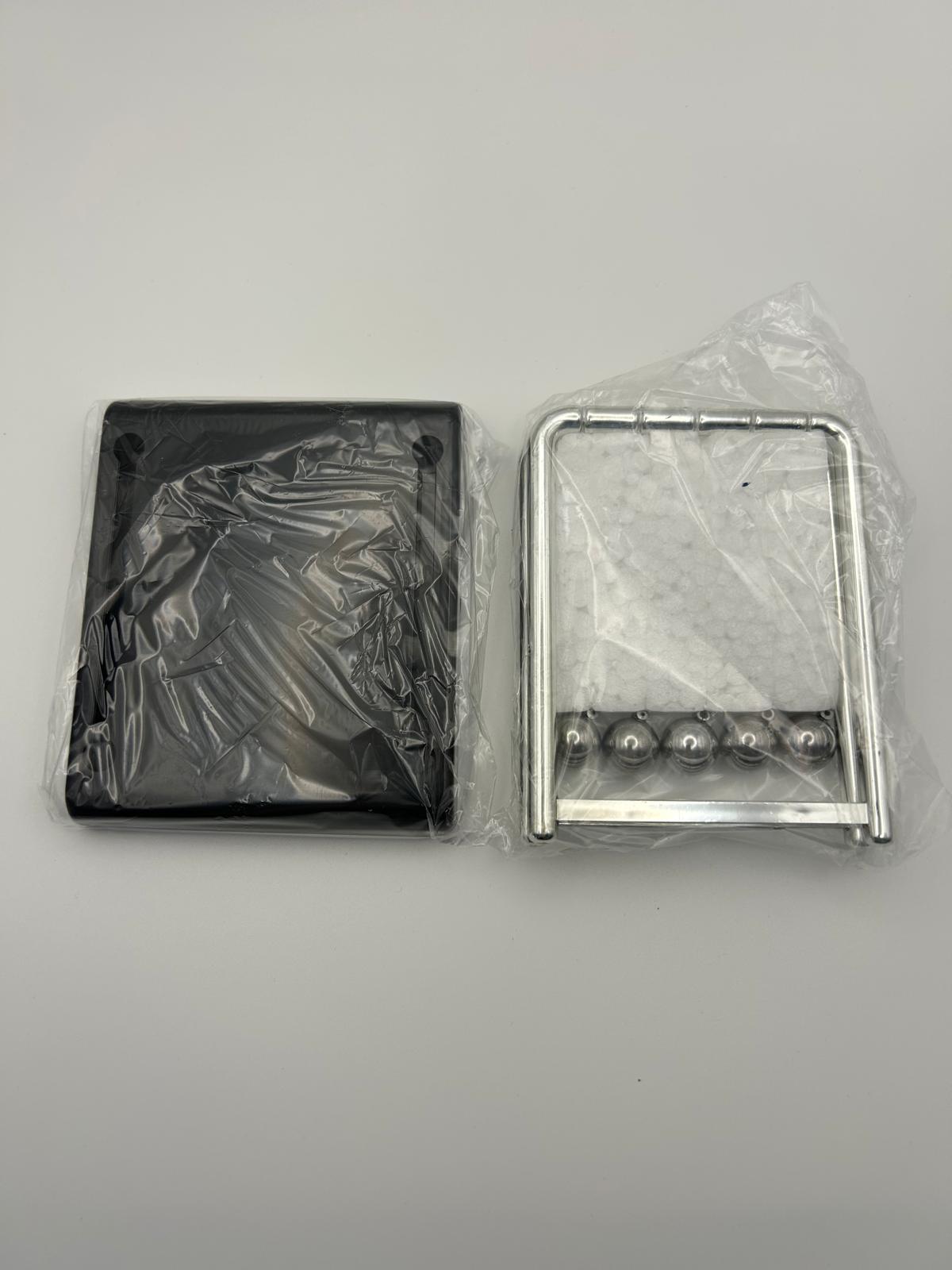 Newton’s Cradle packaging in its film to show what it looks like  – desktop fidget and sensory stress relief toy | The Divergent Den