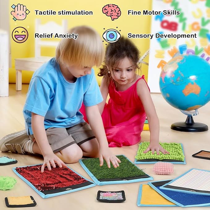 Two children playing with textured mats on the floor, surrounded by educational items.