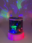 Colorful night light projector with star and rainbow patterns on a white background