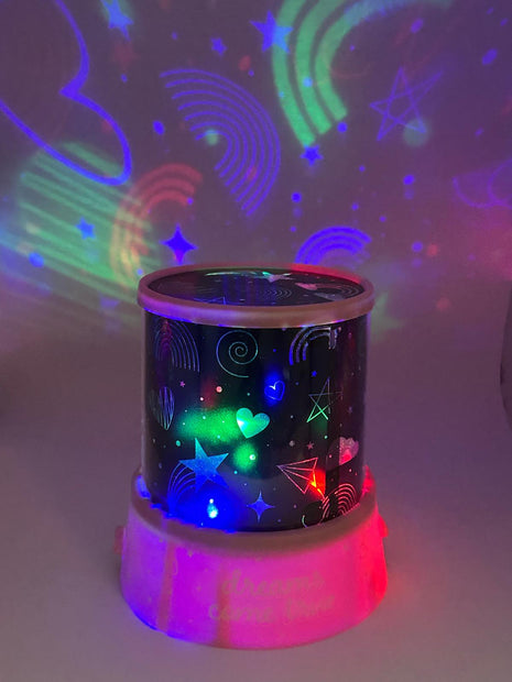 Colorful night light projector with star and rainbow patterns on a white background