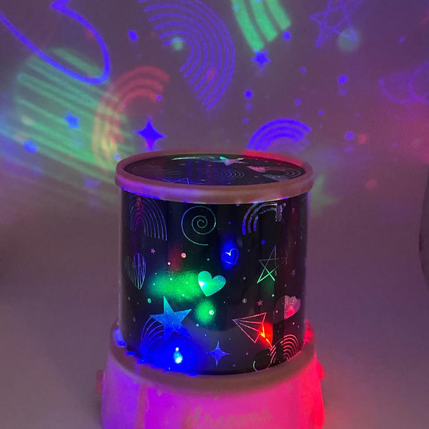 Colorful night light projector with star and rainbow patterns on a white background