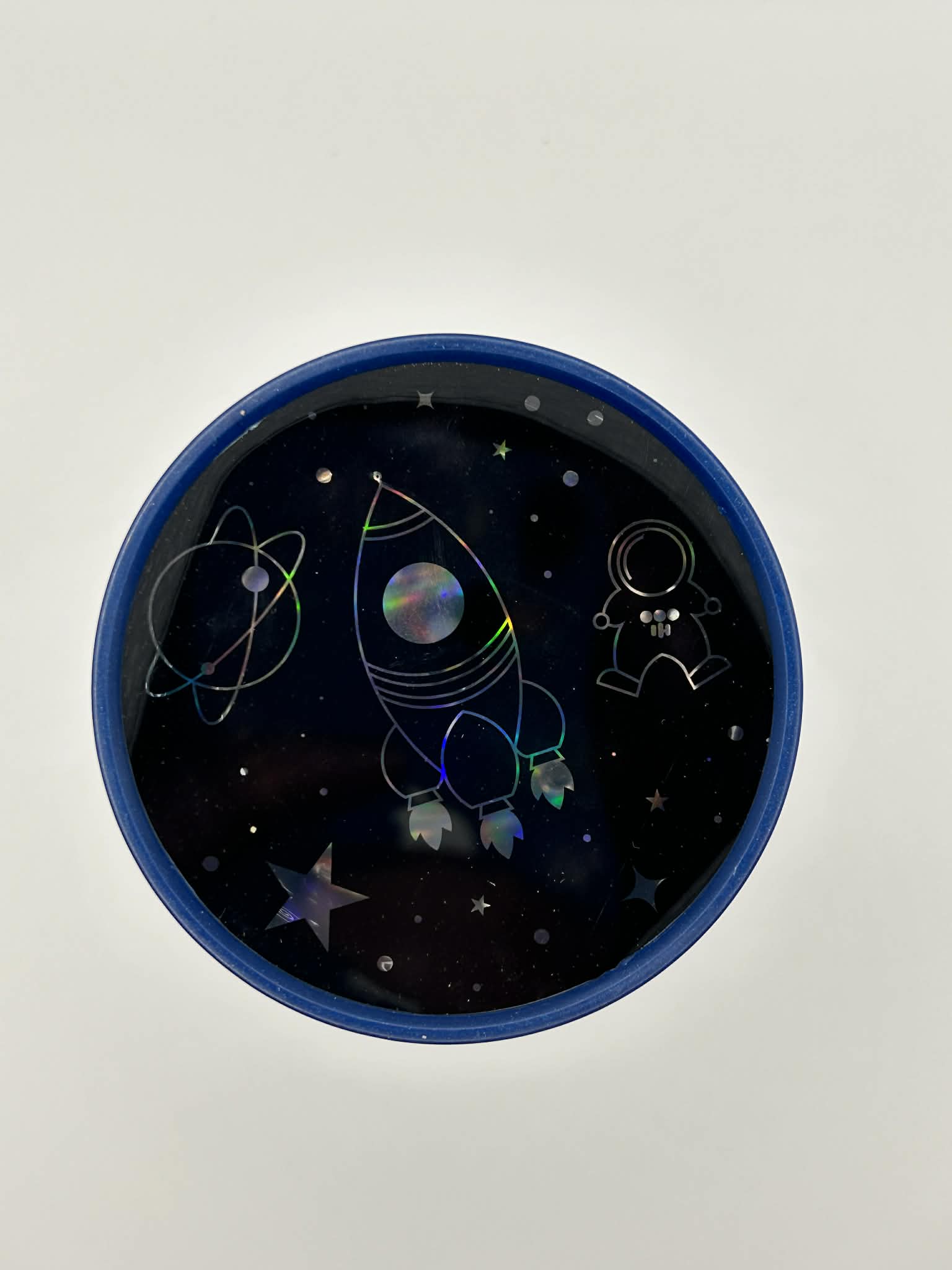 Sensory night light projector space at a top view with space-themed design featuring a rocket and astronaut on a dark background.