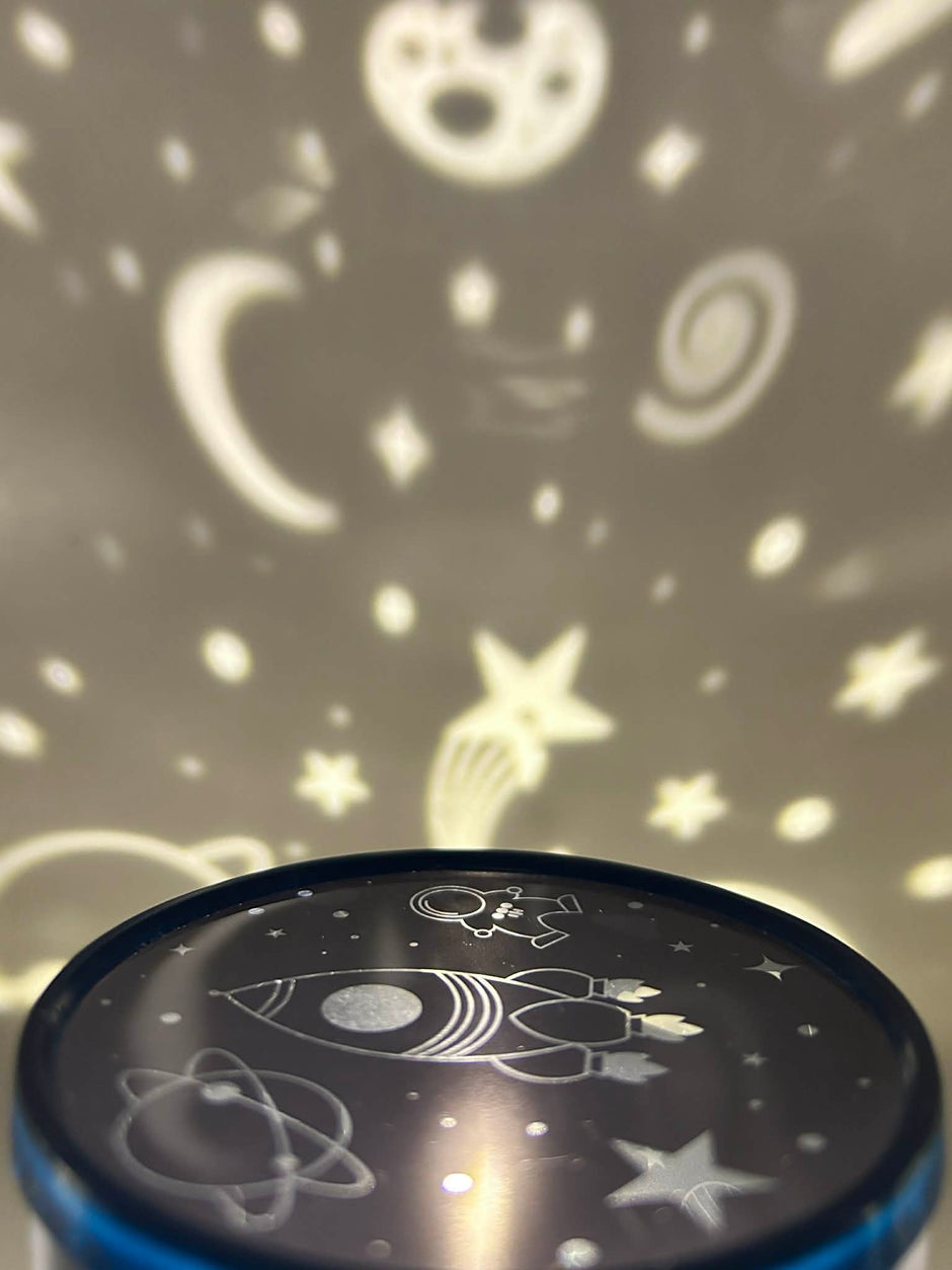 Sensory night light projector | Cosmic design projector with star and moon patterns on a dark background