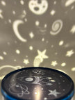 Sensory night light projector | Cosmic design projector with star and moon patterns on a dark background