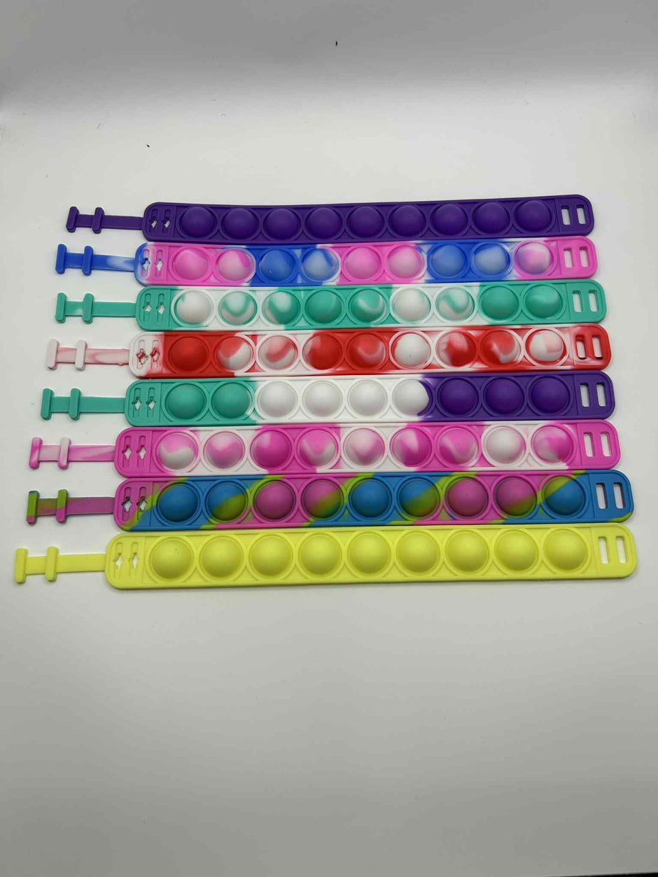 Sensory Pop Bracelet laid out to see the colours and the pop buttons – colourful tactile fidget accessory for neurodivergent children | The Divergent Den