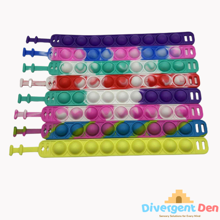 Sensory Pop Bracelet laid out to see the colours and the pop buttons – colourful tactile fidget accessory for neurodivergent children | The Divergent Den