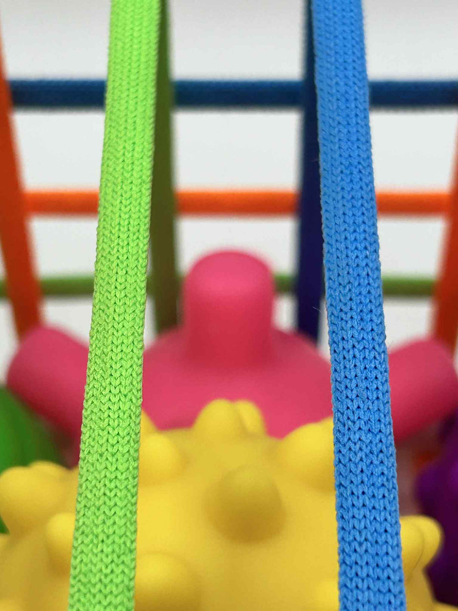 Close-up of Sensory Seekers Sorting Box showing 4 textured balls and soft ribbon openings for sensory play