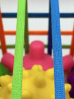 Close-up of Sensory Seekers Sorting Box showing 4 textured balls and soft ribbon openings for sensory play