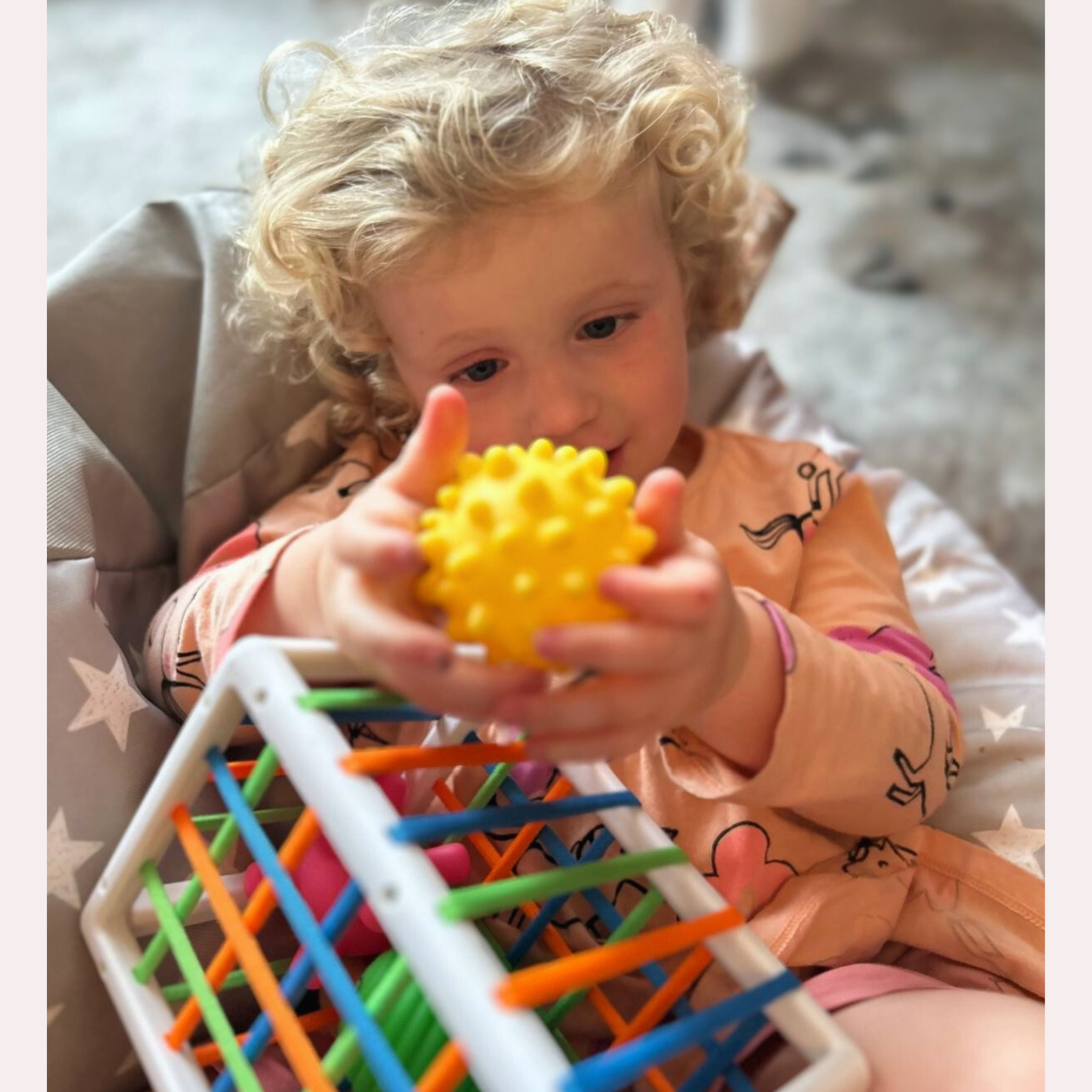 Child playing with Sensory Seekers Sorting Box to develop fine motor skills, hand-eye coordination, and sensory exploration