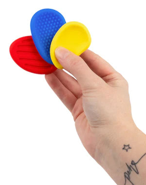 Hand holding Sensory Worry Stone demonstrating thumb rubbing technique for anxiety relief and grounding
