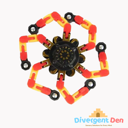 Colorful mechanical model with red, yellow, and black components on a white background, branded 'Divergent Den'.
