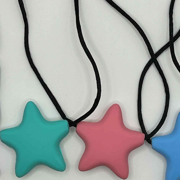 Close-up of Oral Chew Star Necklace showing star shape with multiple chewing points
