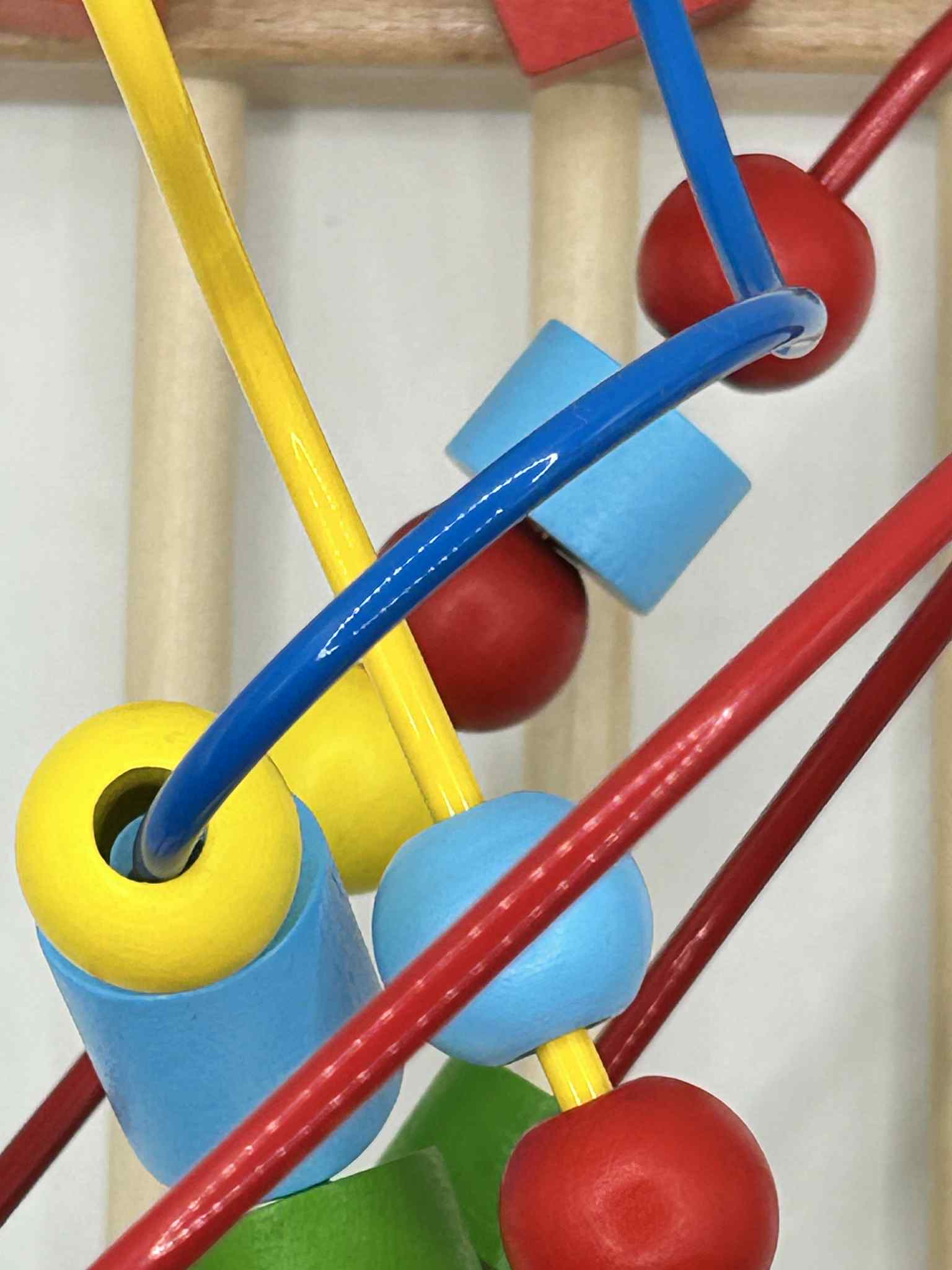 Close-up of Wooden Bead Maze showing colourful wooden beads on wire tracks for tactile play