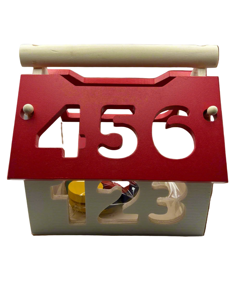 Close-up of Wooden Shape Sorter showing the red roof of the house and the wooden blocks and shape-matching holes for learning play