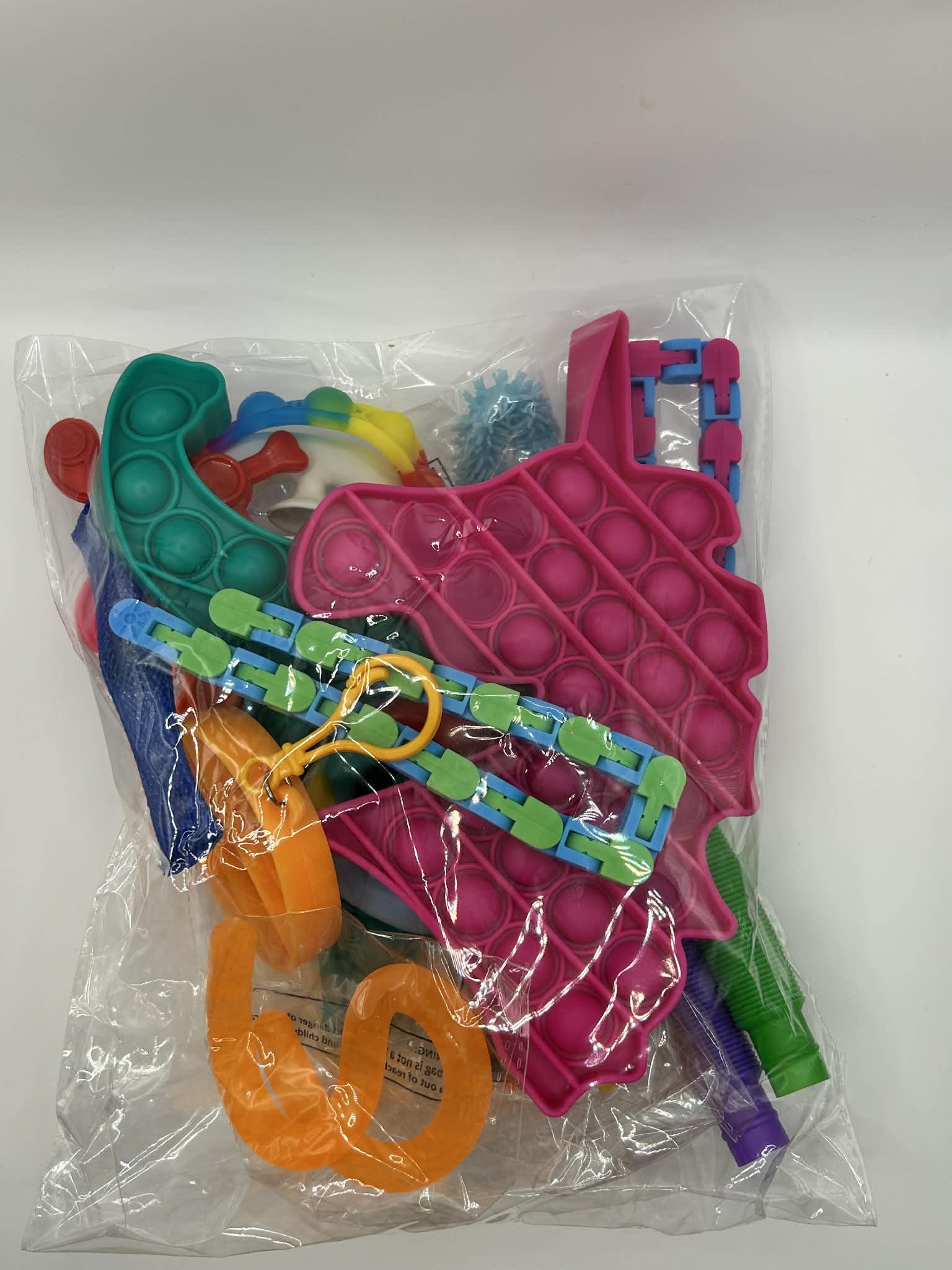 Packaged colorful pop-it fidget toys on a white background