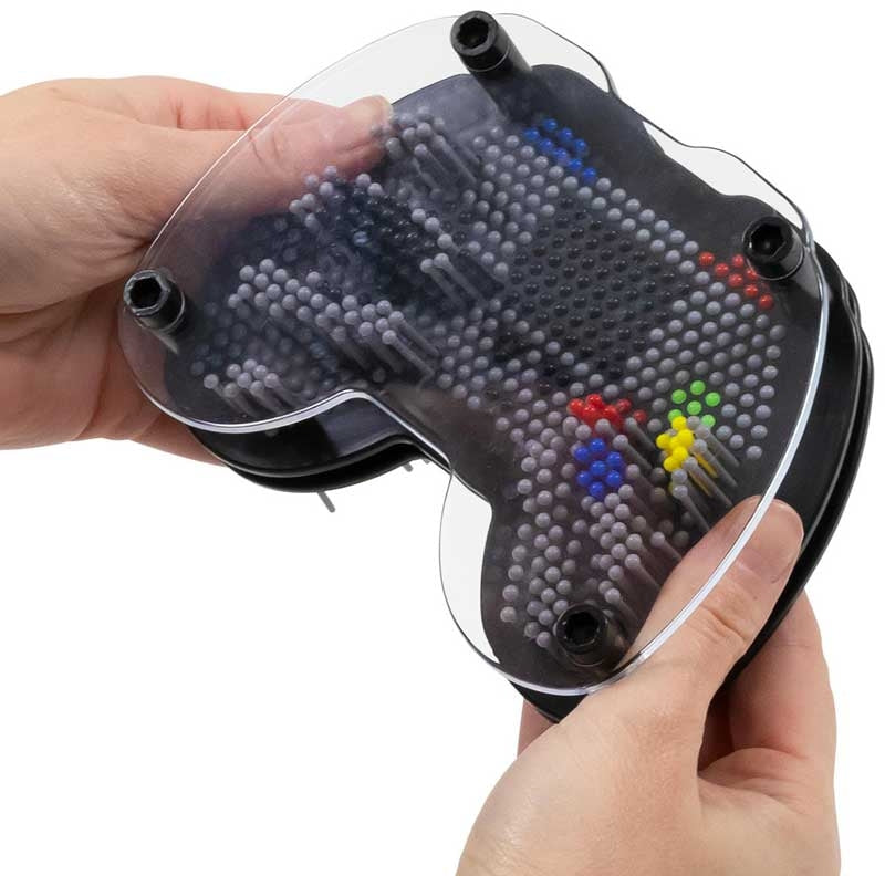 Child pressing pins on games controller pin art tactile sensory fidget for focus and self-regulation